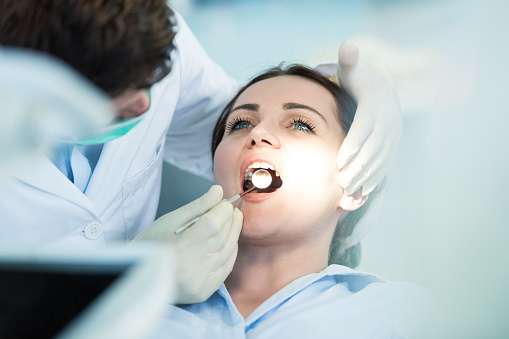 paciente com a boca aberta no dentista